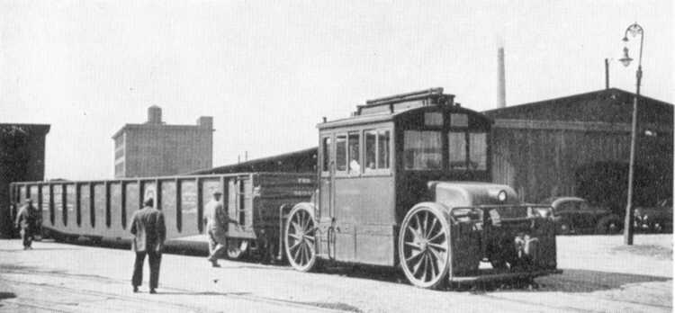 Unknown rubber tired switcher pulling a gondola